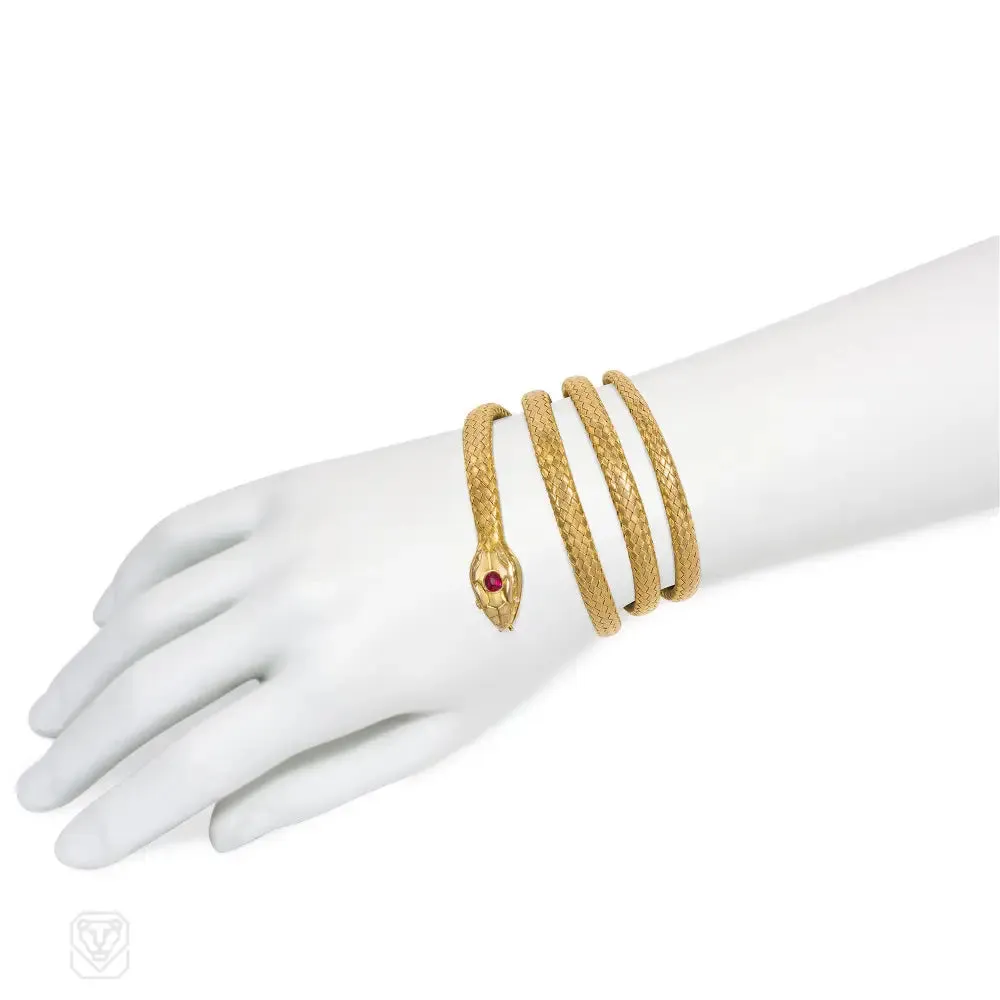Antique woven gold coiled snake bracelet with gemset head